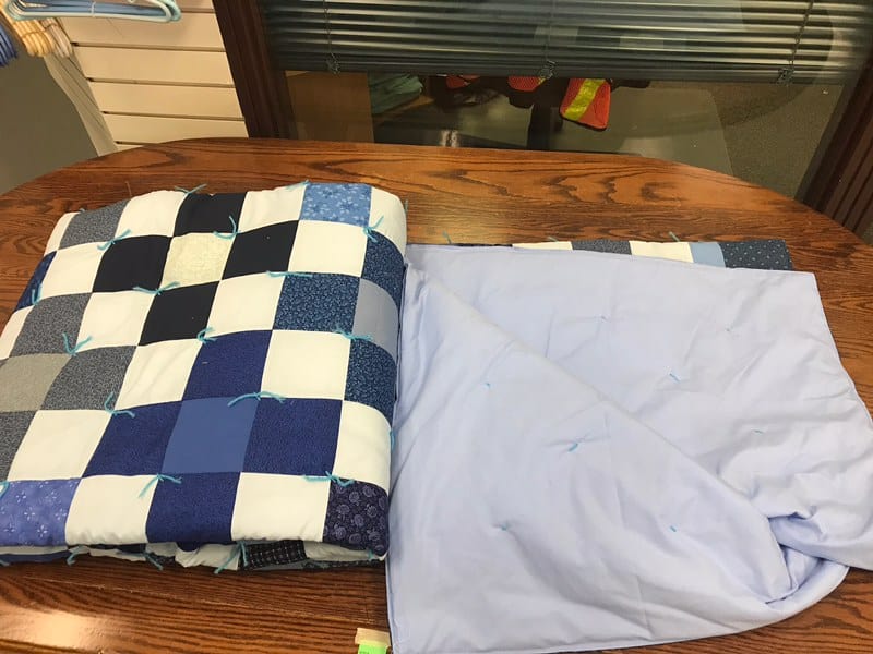 Tied comforter This comforter is machine stitched, in the traditional Mennonite style and is as cozy as it is warm Dimensions are 87” x 97” Starting bid is $150. Bid and view at